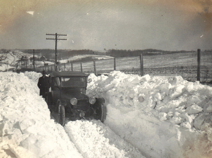 Line of dealer cars on snowy road
