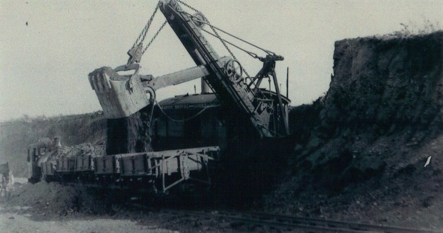 Grading Massachusetts Ave (cutting it down)