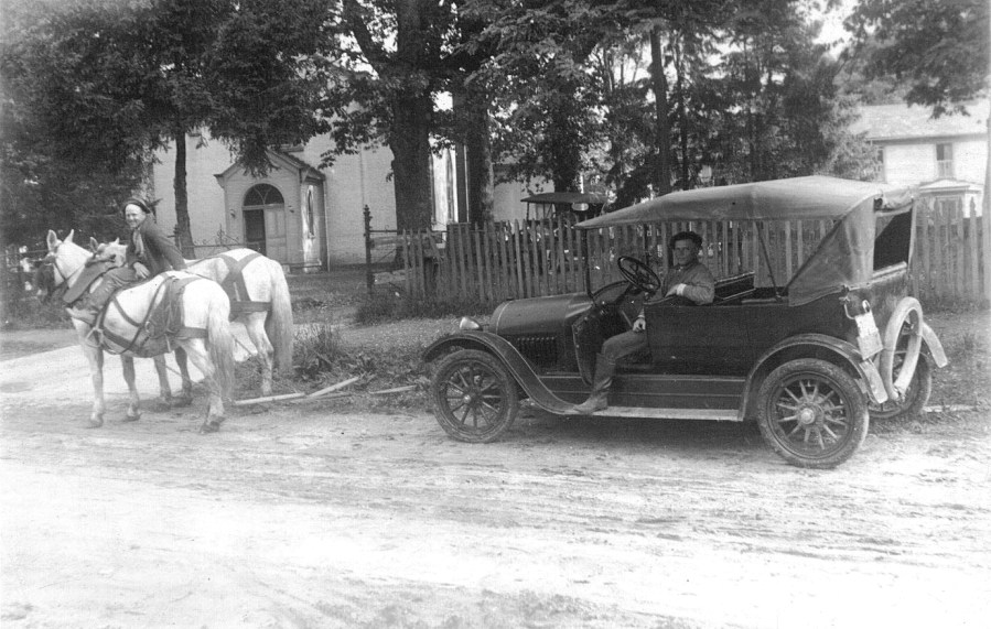 horse towing old car
