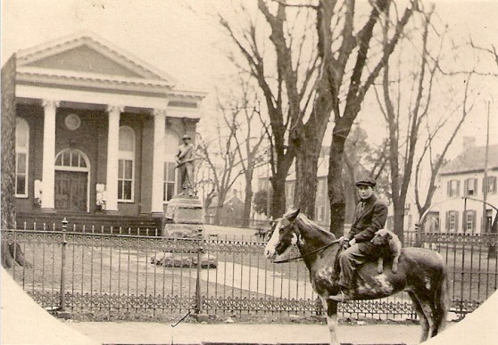 Man and his dog on a horse