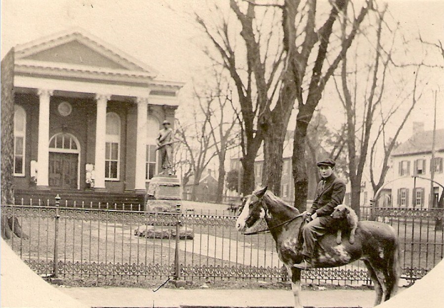 Man and his dog on a horse