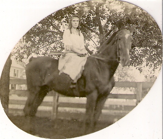 woman holding rifle on horse