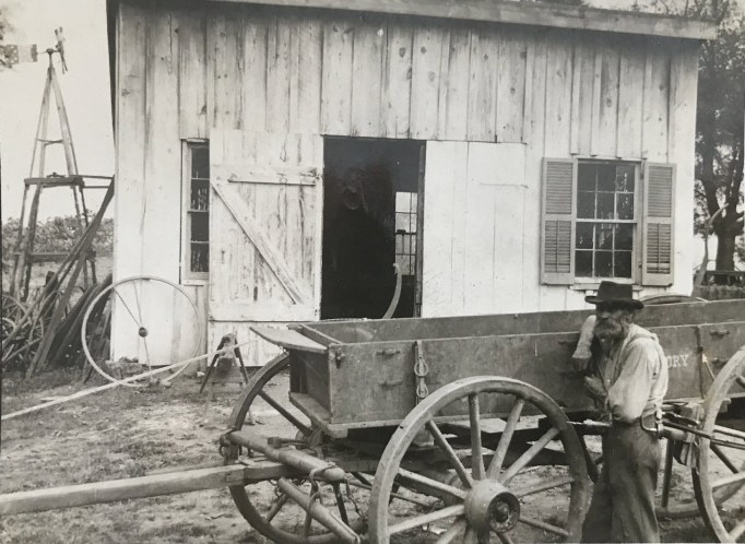 Philip Reed outside of his Blacksmith Shop ca. early 1900s.
