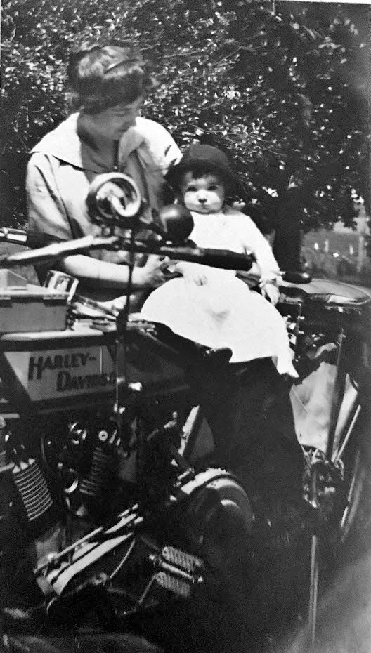 Woman and toddler on Harley Davidson motorcycle, ca. 1912